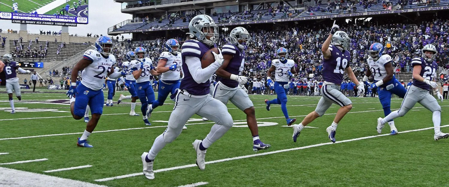 A Kansas State Wildcats player running in a touchdown