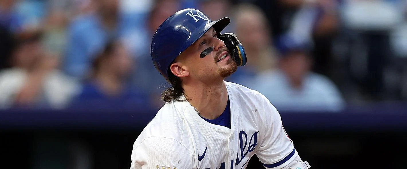 A Kansas City Royals batter watching a ball leave the park